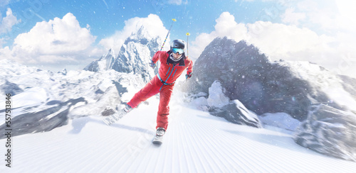 Фотография Skier skiing on a sunny day in high mountains