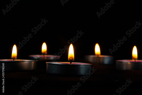 Φωτογραφία Candles of peace with dark bg and yellow flame on the dark.