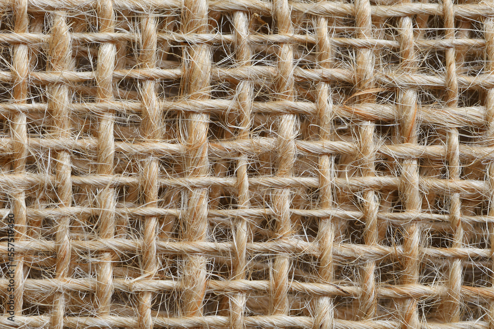 Extreme close-up flat brown piece of Hessian material coarse fibres soft light filling the frame Extreme close-up flat brown piece of Hessian material coarse fibres soft light filling the frame