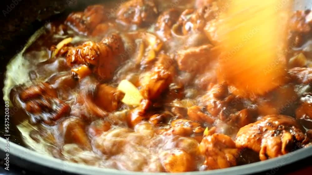Cooking chopped chicken stew in pan, in door Chiangmai Thailand Cooking chopped chicken stew in pan, in door Chiangmai Thailand