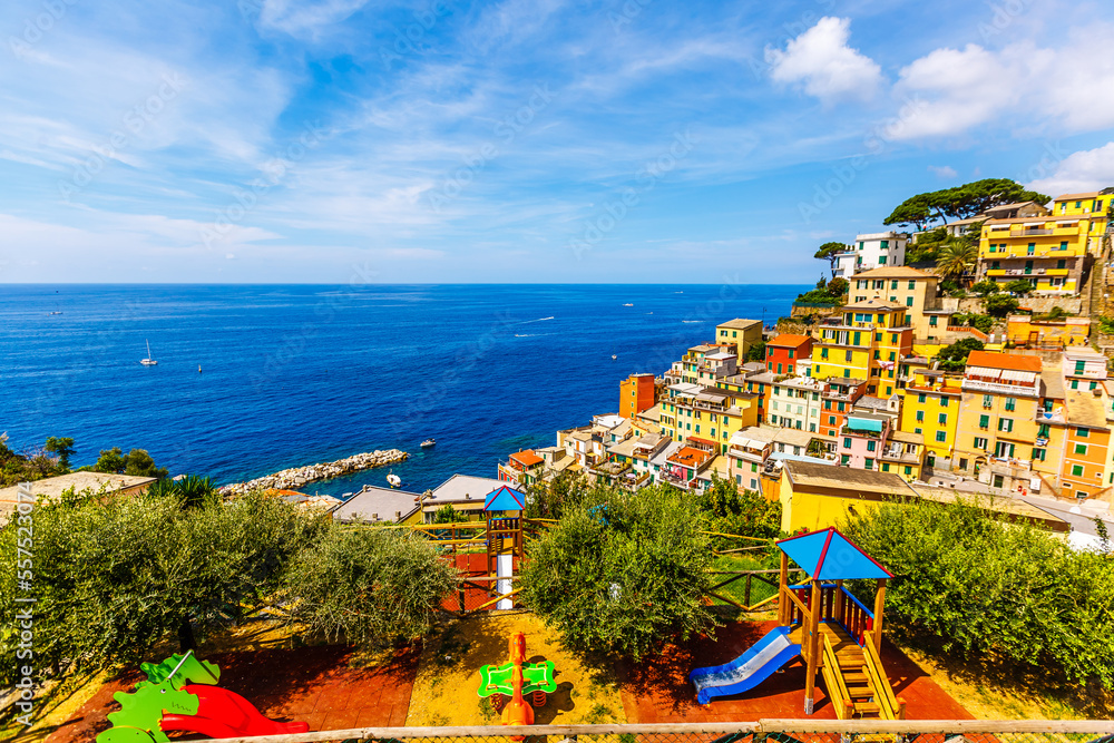 Classic View of Manarola - Colorful Houses in a Dramatic Cliff Rock Formation near the Sea with a Fishing Natural Harbor.