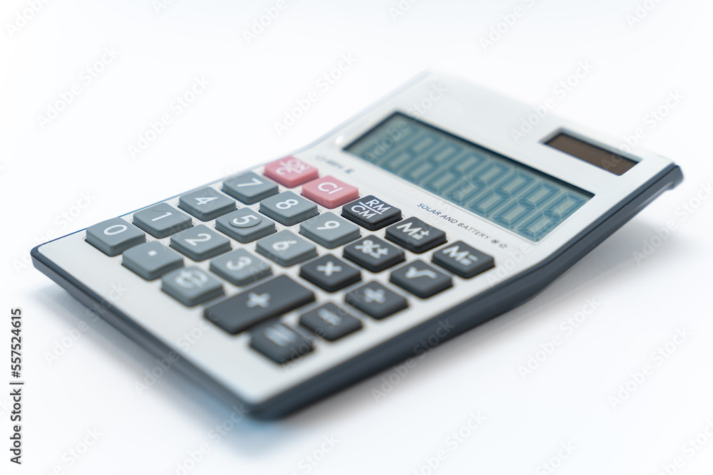 A white digital calculator isolated on white background. Calculator with Solar and battery function. A white digital calculator isolated on white background. Calculator with Solar and battery function.