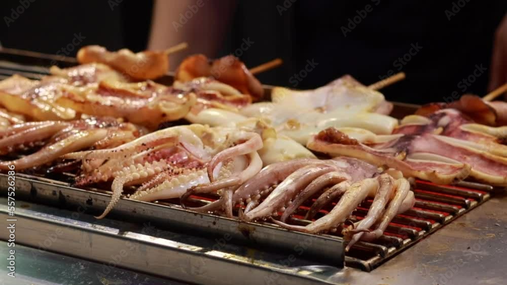 Big squid being grilled on the stove, street food, 4k video Big squid being grilled on the stove, street food, 4k video