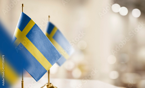 Small flags of the Sweden on an abstract blurry background