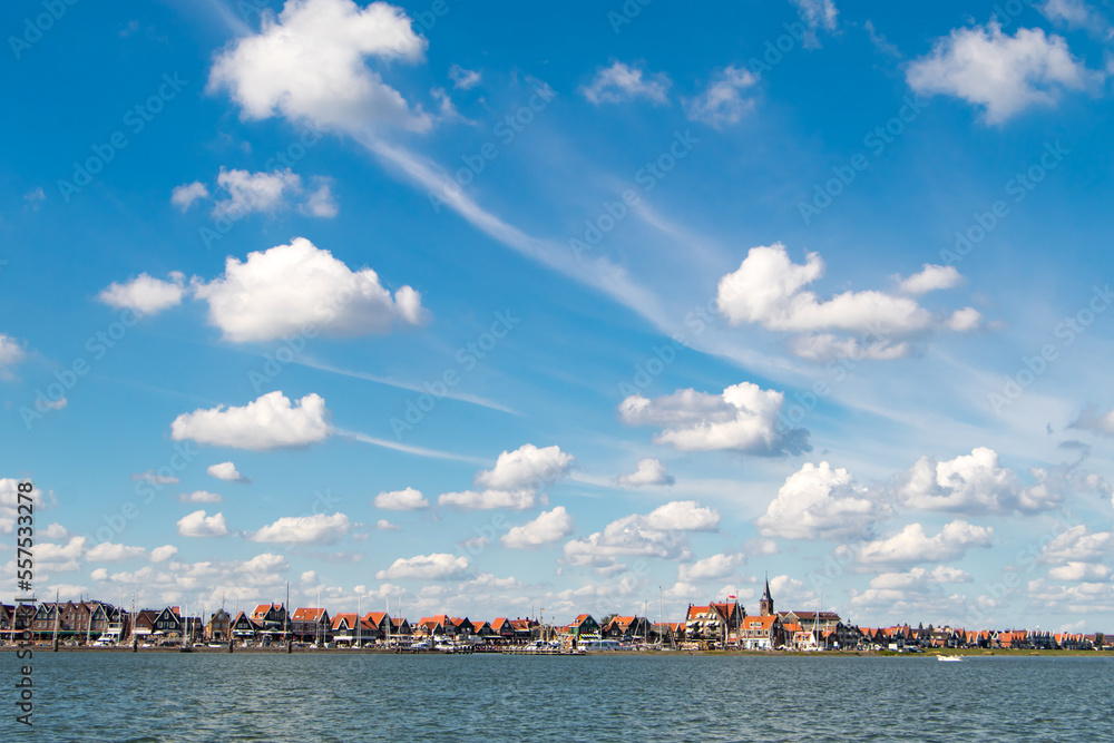 The Dutch city of Volendam seen from the water under majestic clouds
