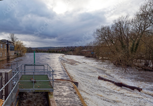 The weir at the River Wharfe in Otley with the river in spate after heavy rain throughout Yorkshire in late Winter. photo