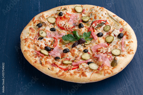 Delicious pizza with olives and sausages on wooden table