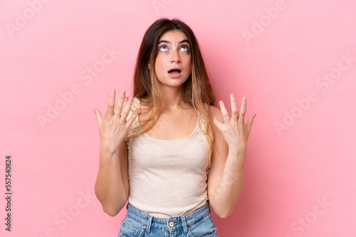 Young caucasian woman isolated on pink background stressed overwhelmed