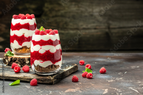 Scottish dessert whipped cream, roasted oatmeal and raspberries in jar. banner, menu, recipe place for text, top view photo