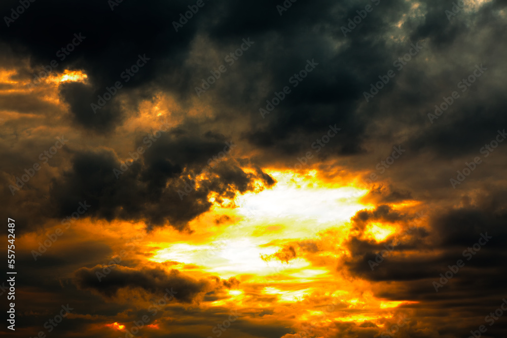 Fototapeta premium Dark clouds with glowing sun . Weather before storm 