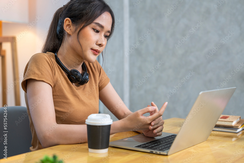Asian female student sitting at home studying at home typing homework reports to send to teachers online feeling joint pain and fatigue using the keyboard at home.
Asian female student sitting at home studying at home typing homework reports to send to teachers online feeling joint pain and fatigue using the keyboard at home.