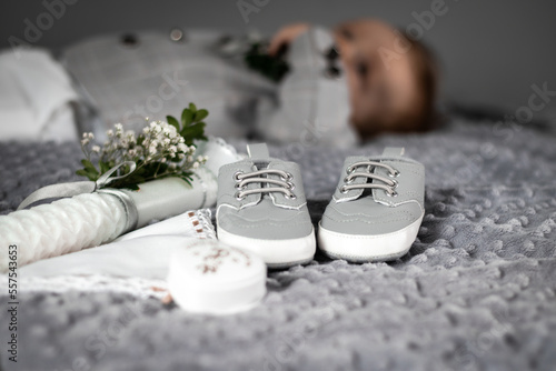 Baptism decoration with candle shoes, rosary and boy photo