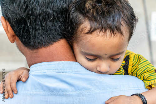 Asian refugee with his sick child at a border