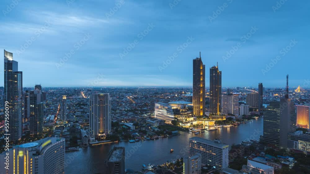Zoom out day to night time lapse of Bangkok skyline and Chao Phraya river at Taksin bridge area with riverside business and residential buildings Zoom out day to night time lapse of Bangkok skyline and Chao Phraya river at Taksin bridge area with riverside business and residential buildings