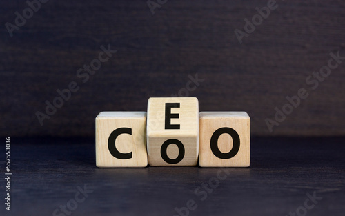 CEO or COO symbol. Concept word CEO chief executive officer or COO chieve operating officer on wooden cubes. Beautiful black table black background. Business and CEO or COO concept. Copy space.