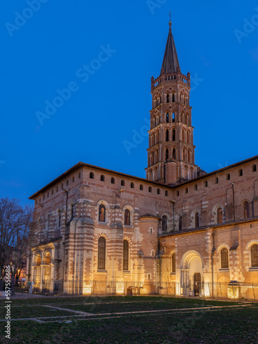 Vertical landscape view of famous landmark St Sernin basilica illuminated after sunset, Toulouse, France 