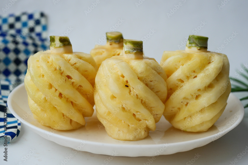 slice of pineapple in bowl on table slice of pineapple in bowl on table
