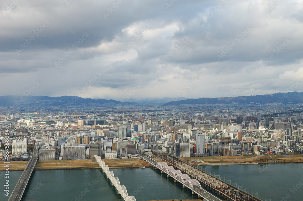Fototapeta premium Overhead view of Osaka's Umeda area from a hill on a cloudy day