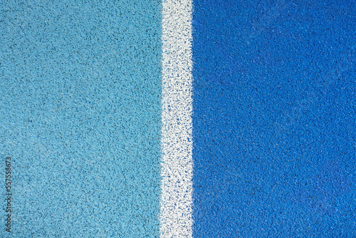 part of the athletic field with a vertical white line. top view. Texture of color rubber floor on playground