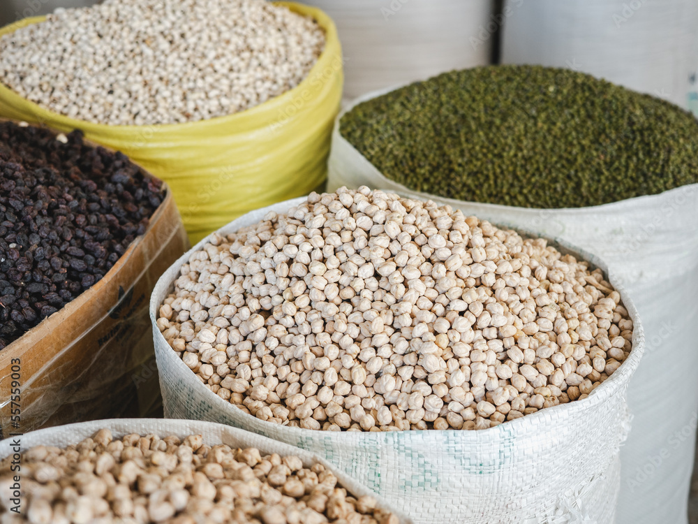 Bags and bowls with fragrant spices lying in the market on a sunny, clear day. Closeup, outdoors, no people. Tasty and healthy food concept Bags and bowls with fragrant spices lying in the market on a sunny, clear day. Closeup, outdoors, no people. Tasty and healthy food concept