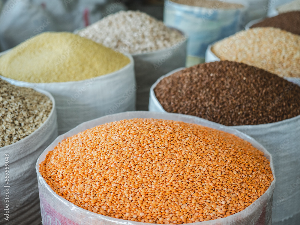 Bags and bowls with fragrant spices lying in the market on a sunny, clear day. Closeup, outdoors, no people. Tasty and healthy food concept Bags and bowls with fragrant spices lying in the market on a sunny, clear day. Closeup, outdoors, no people. Tasty and healthy food concept