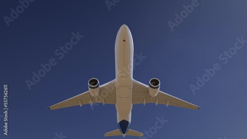 Airplane flying on clear blue sky.