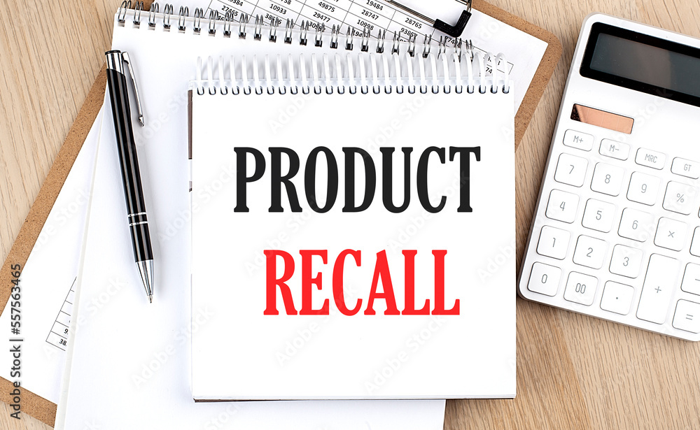 PRODUCT RECALL is written in white notepad near a calculator, clipboard and pen. Business concept PRODUCT RECALL is written in white notepad near a calculator, clipboard and pen. Business concept