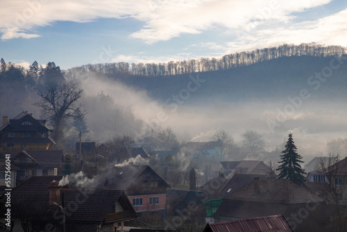 Landscape with fog and smoke above a village in the morning