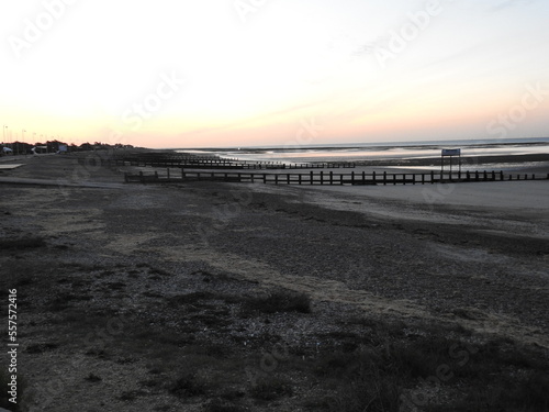 View of the sea and a huge empty beach at low tide early in the morning