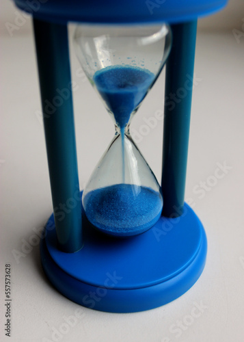Hourglass with falling sand counting down the time top angle view 