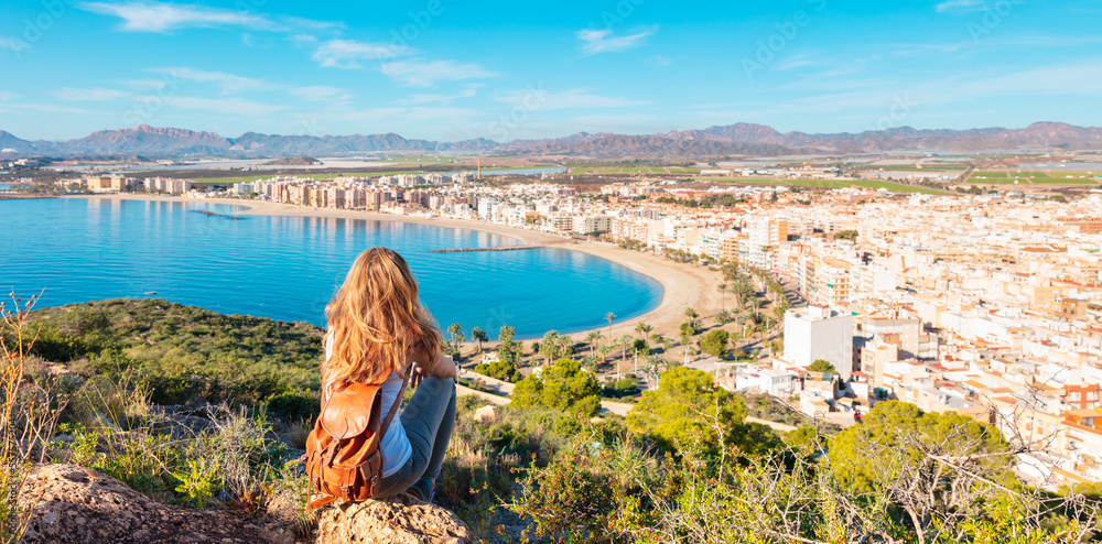 Woman tourist looking at panoramic view of Aguilas,  Murcia province in Spain