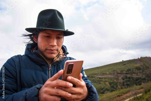 Long-haired man in hat walking in remote nature