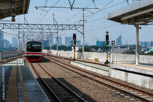 train on railway, train on station, railway station in the city, railway in the city, Manggarai Station in Jakarta photo