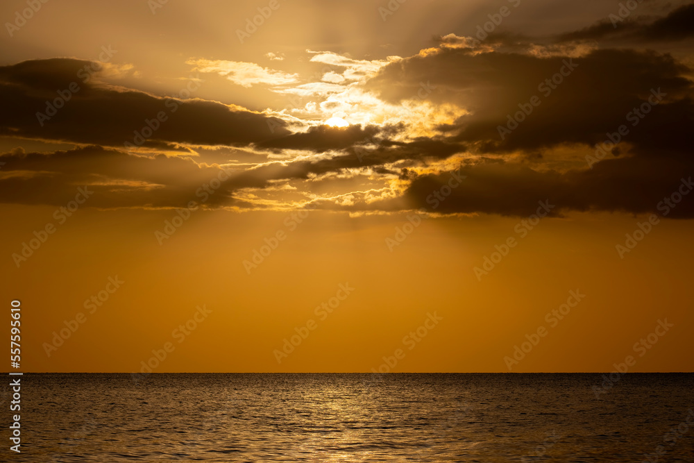 Fototapeta premium Dramatic red ocean waves at sunset with soft evening sea dark water