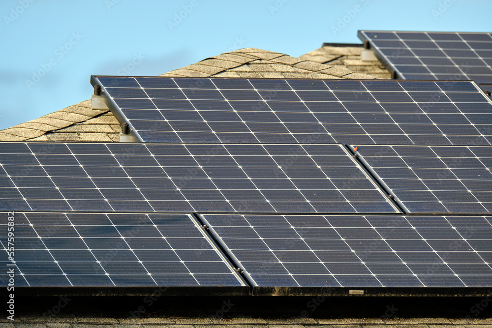Private home roof covered with solar photovoltaic panels for generating of clean ecological electric energy in suburban rural town area. Concept of autonomous house Private home roof covered with solar photovoltaic panels for generating of clean ecological electric energy in suburban rural town area. Concept of autonomous house