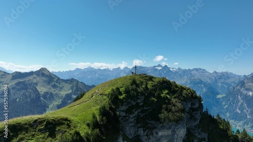 Mountain aerial, alps in switzerand in summer time. Hiking paradise and cross on top of the mountain. Peak and green summer landscape. Touristic destination in Europe. Aerial drone. photo