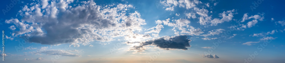 Fototapeta premium Panoramic view of sunset sky with clouds and sun.