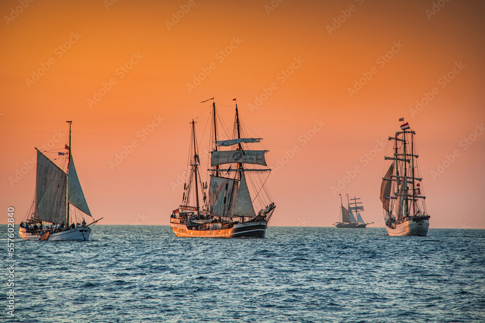 sailboat returning to port at sunset