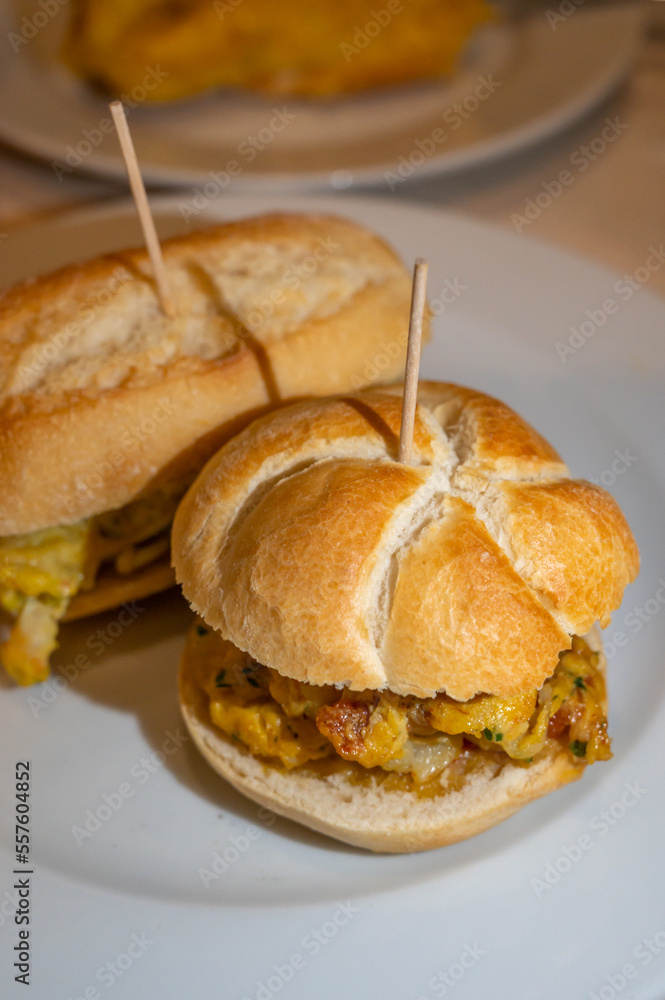 Typical mini burger snack of Basque Country, pinchos or pinxtos, small piece of bread with different toppings, served in bar in San-Sebastian or Bilbao, Spain Typical mini burger snack of Basque Country, pinchos or pinxtos, small piece of bread with different toppings, served in bar in San-Sebastian or Bilbao, Spain