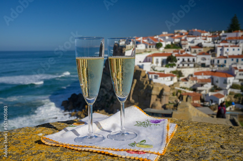 Glasses of champagne sparkling wine and view on white houses of picturesque village Azenhas do mar, Lisbon area, Portugal photo
