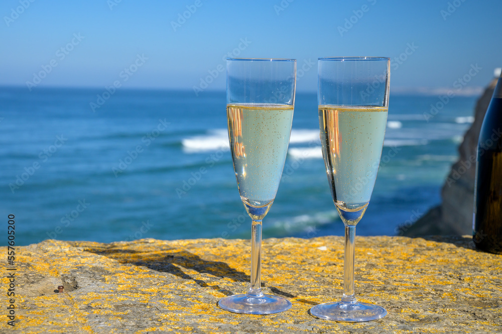 Glasses of champagne sparkling wine and view on blue Atlantic ocean, Lisbon area, Portugal Glasses of champagne sparkling wine and view on blue Atlantic ocean, Lisbon area, Portugal
