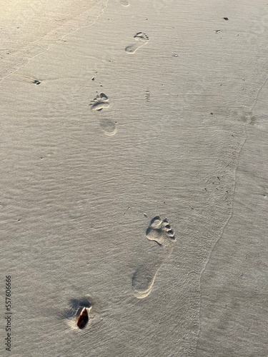 human footprints in the sand on the beach