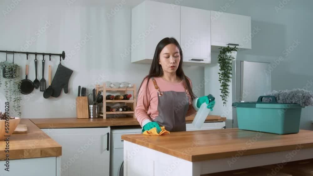 Happy Asian young woman sweeping sofa and furniture to cleaning house, healthy lifestyle concept
