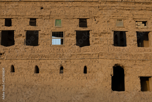 One of the old houses where people used to live, which were built with mud and traditional wooden windows in Al Hamra, oman
 photo