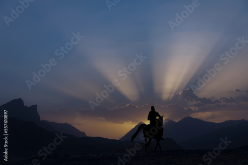 picture of a knight riding his horse in a beautiful sunset 