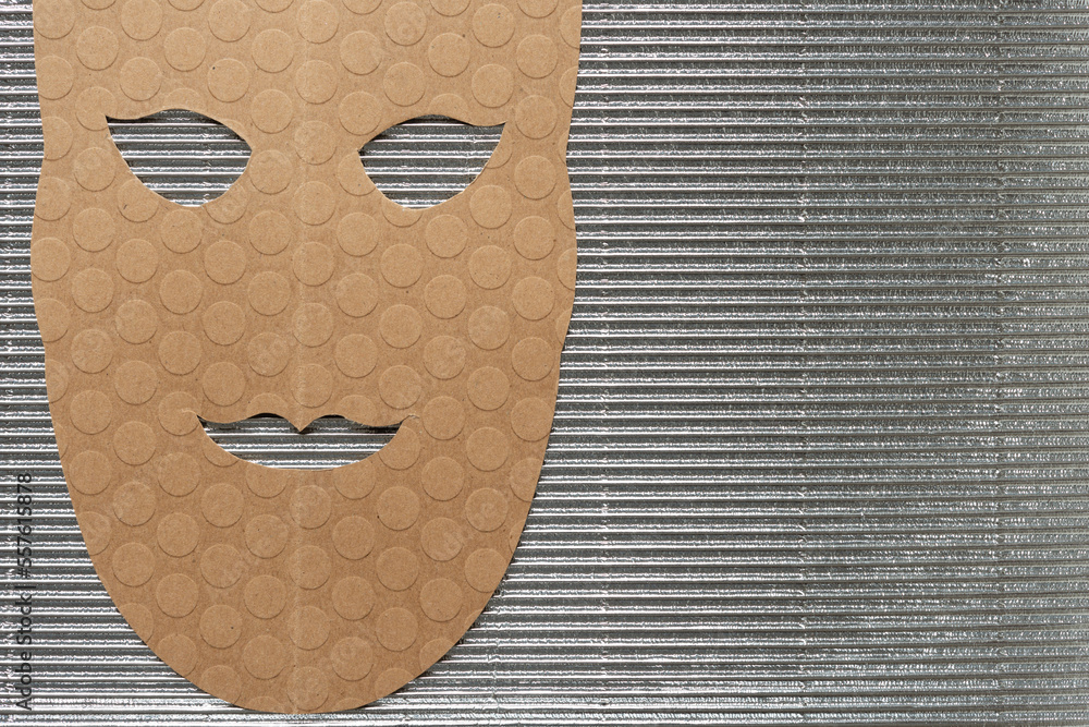 brown paper theatrical mask on corrugated texture - obrazy, fototapety, plakaty 