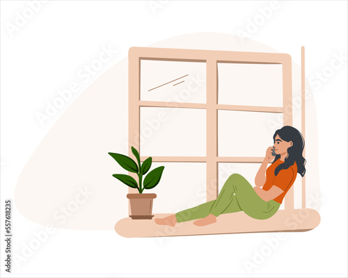 A young woman is sitting on the windowsill and talking on the phone. Flat vector illustration
