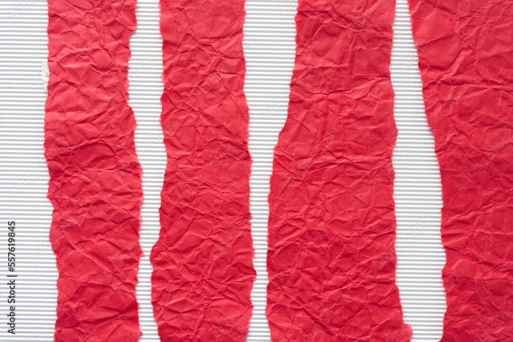 torn red paper stripes on corrugated texture background