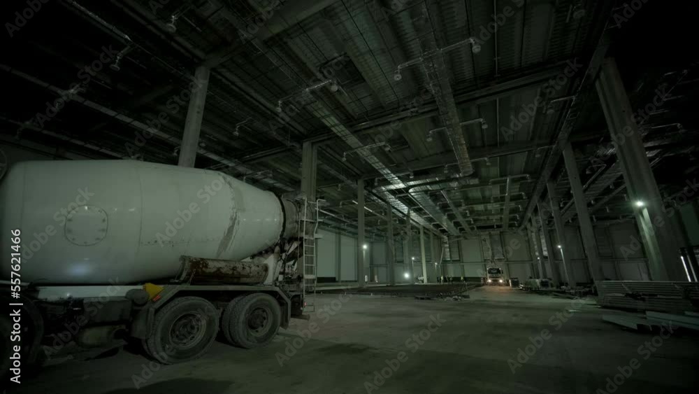 The concrete mixer at the industrial plant. Builders are building a factory, hangar.