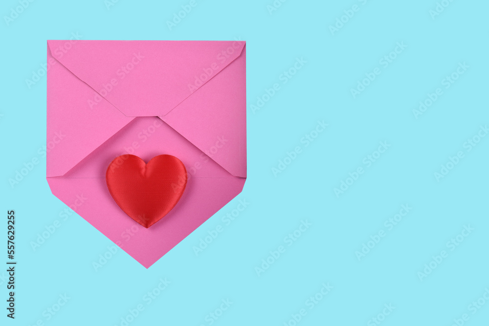 Valentines Day Concept. Red Heart on a pink envelope, with teal background and copy space. Valentines Day Concept. Red Heart on a pink envelope, with teal background and copy space.